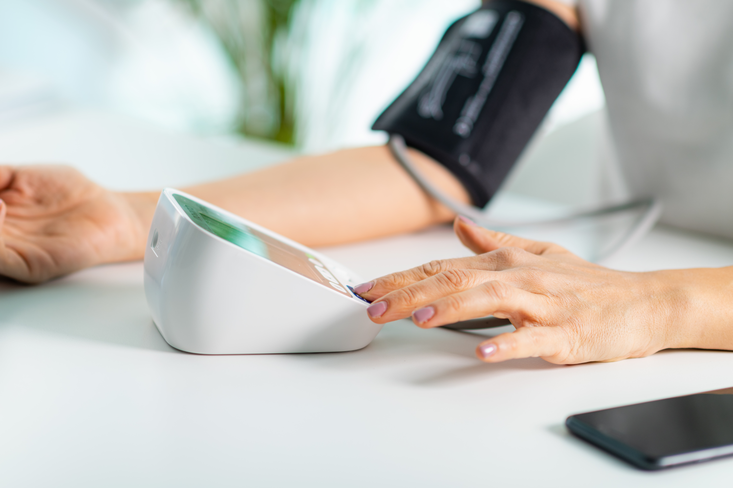 A senior comfortably checking their health at home with a modern device