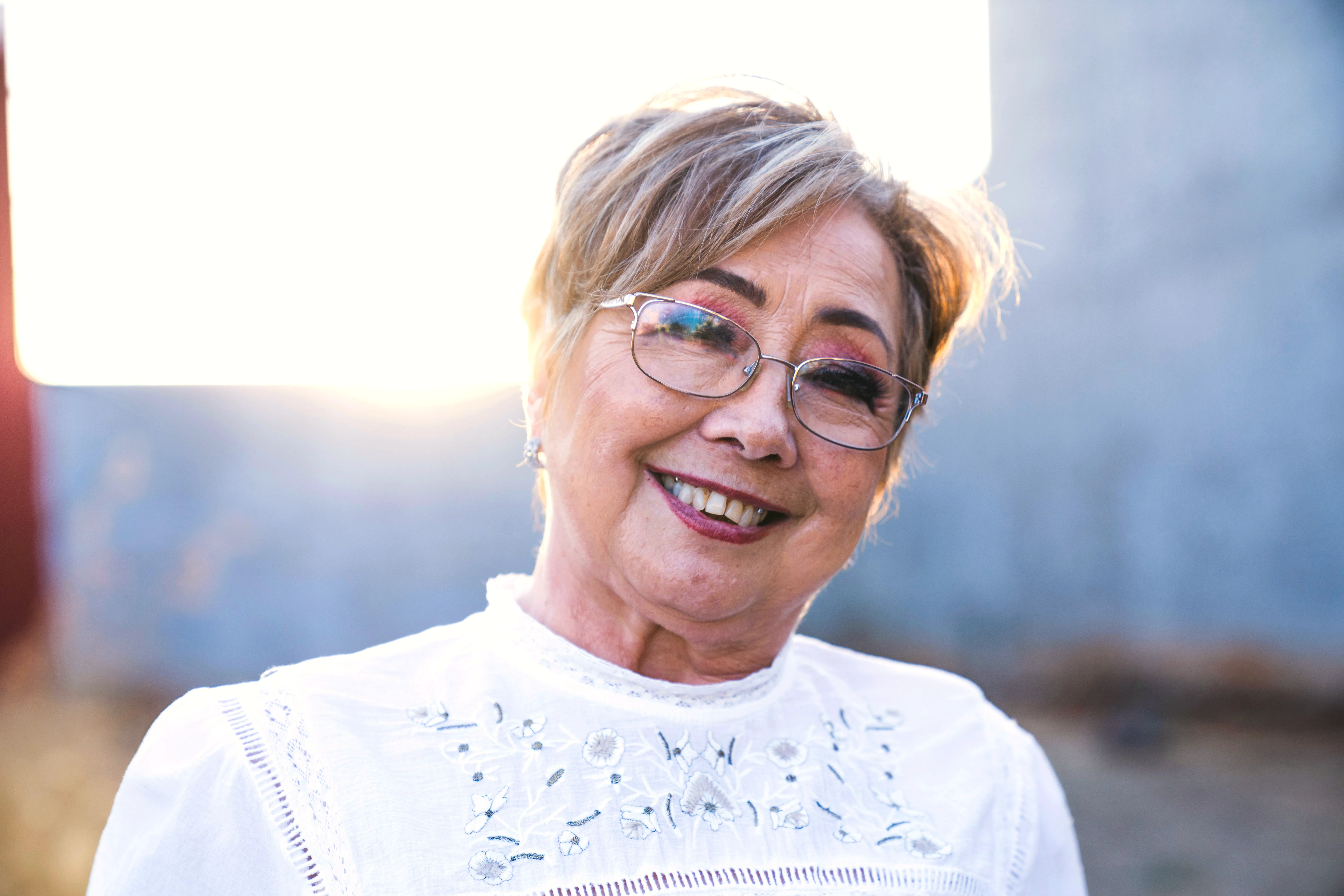 A smiling senior woman enjoying a sunny day outdoors