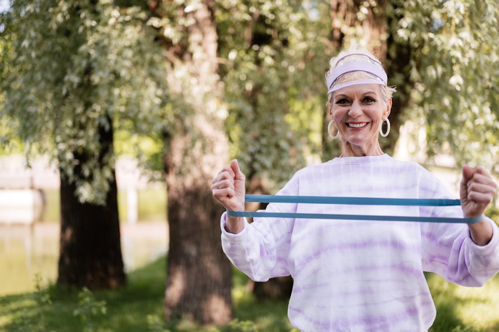 Active senior woman exercising outdoors, feeling strong and healthy