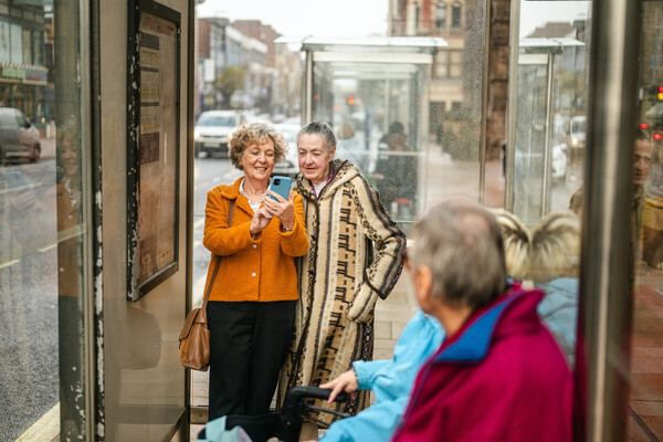 A senior woman delighted while on her phone