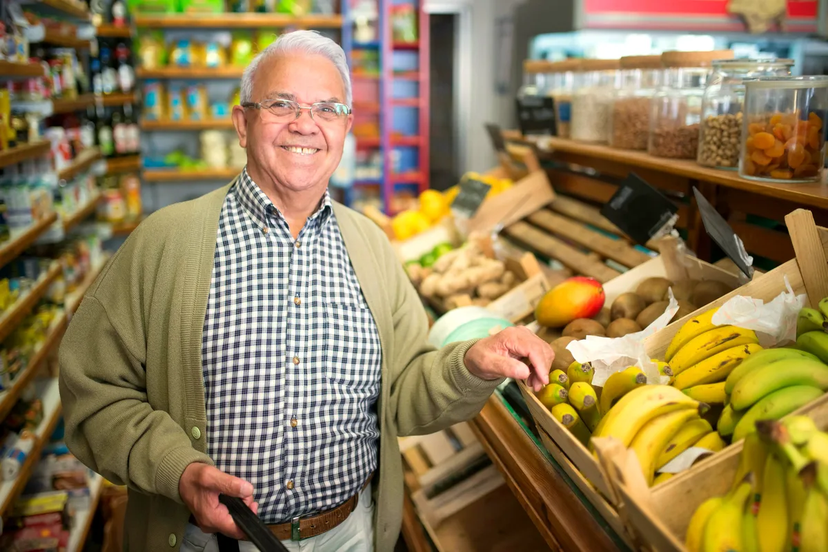 Senior man selecting fresh produce at a market