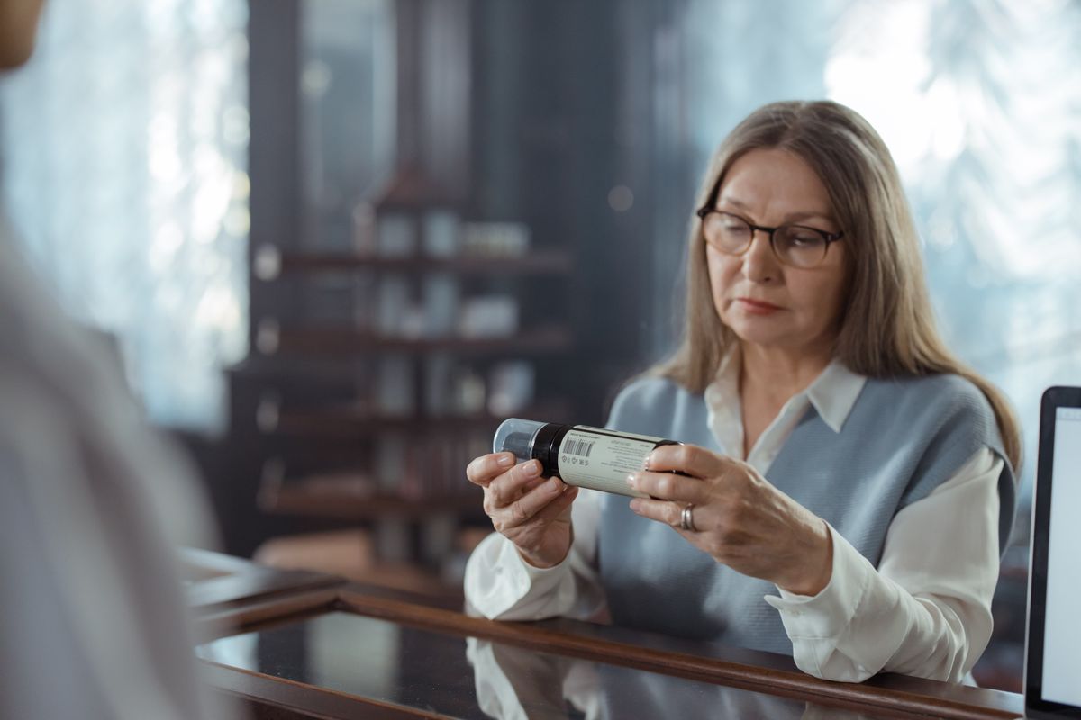 A senior woman examining her medication