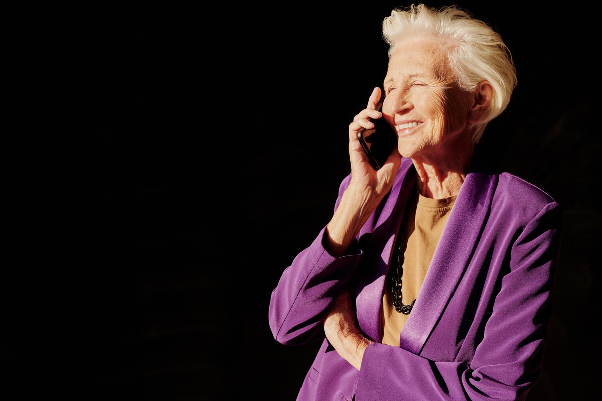 A senior woman smiling on a warm phone call with Ramona